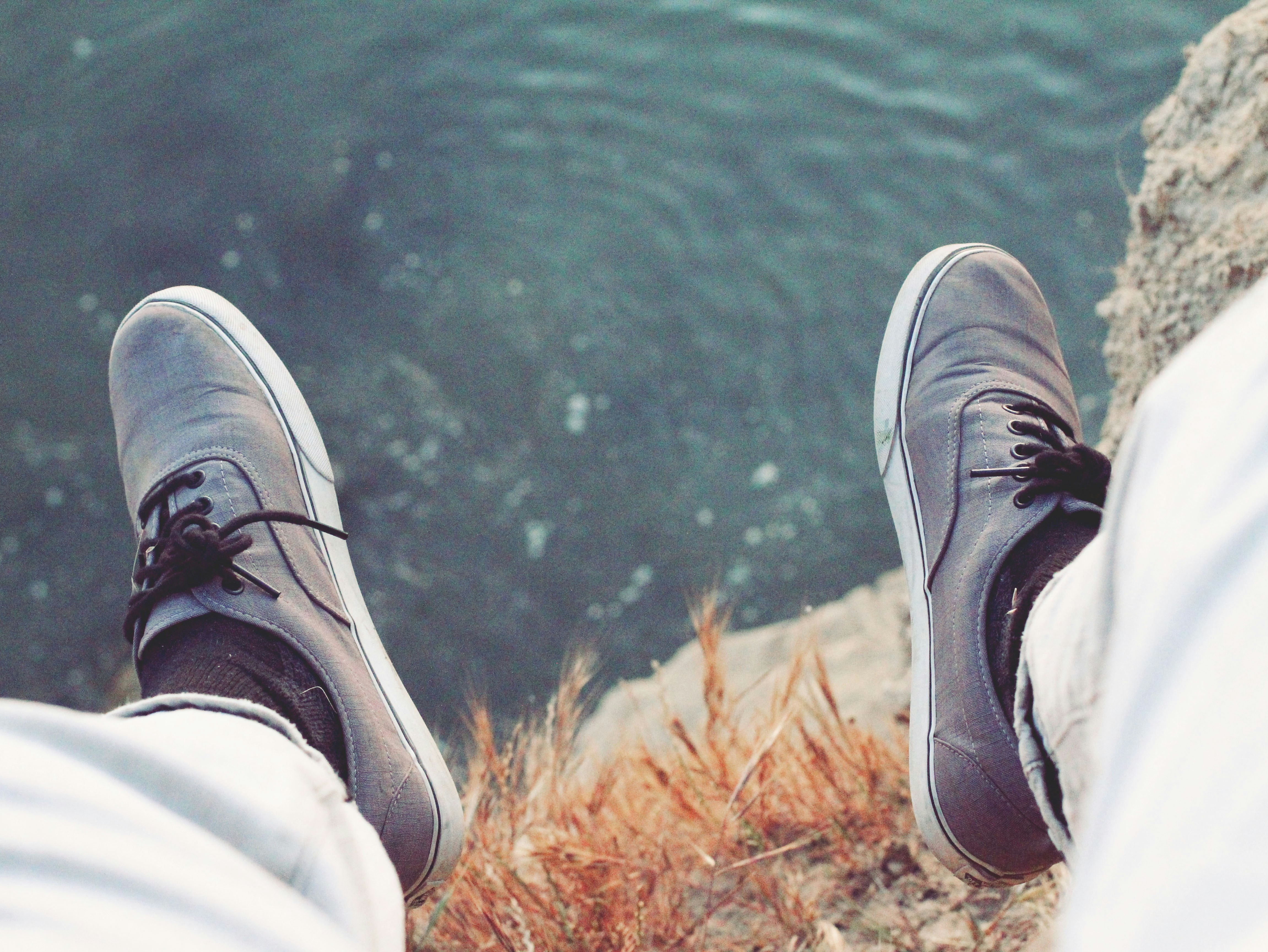 man wearing grey low-top sneakers